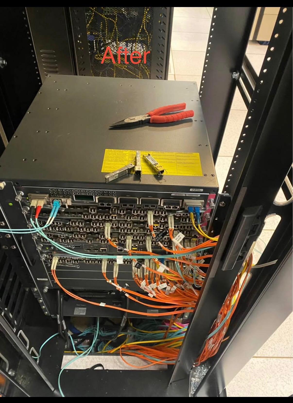 The same network rack photographed after cabling work